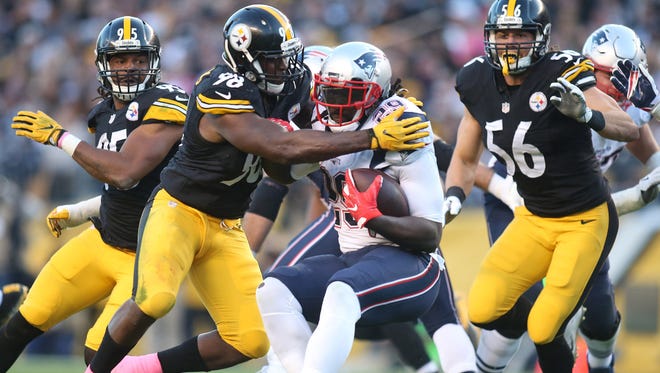 Pittsburgh Steelers inside linebacker Vince Williams (98) tackles New England Patriots running back LeGarrette Blount (29) during the second quarter at Heinz Field.