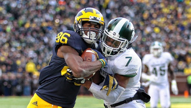 Oct 17, 2015; Ann Arbor, MI, USA; Michigan Wolverines receiver Jehu Chesson is defended by Michigan State Spartans defensive back Demetrious Cox during the 2nd half of a game at Michigan Stadium.