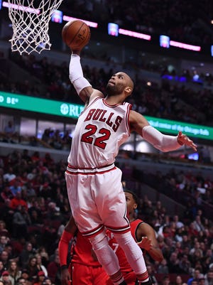 Chicago Bulls forward Taj Gibson dunks the ball against the Toronto Raptors during the first half at the United Center.