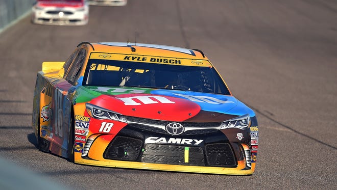 Chase finale: Kyle Busch heads into a turn during the Ford EcoBoost 400. Busch came up short in his bid for back-to-back championships and finished sixth.