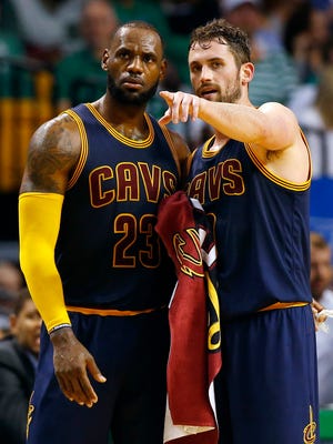 Kevin Love talks with LeBron James during the second half against the Boston Celtics.