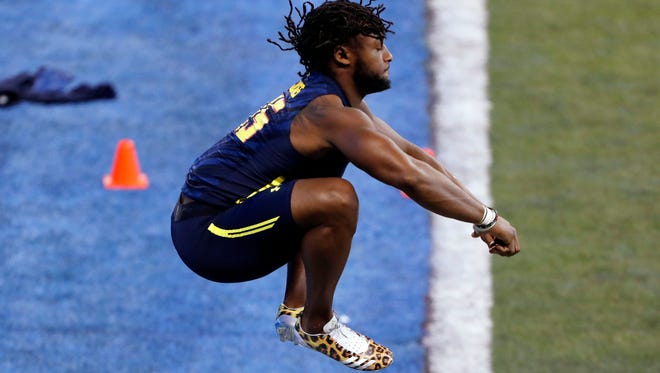 UTEP running back Aaron Jones jumps up to stretch his legs before running the 40 yard dash during the 2017 NFL Combine at Lucas Oil Stadium.