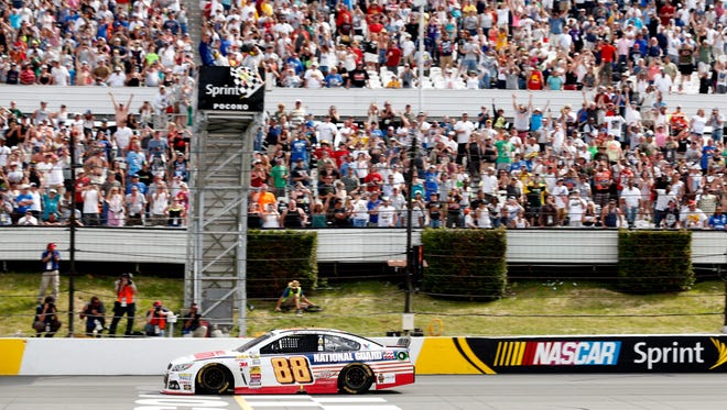 Dale Earnhardt Jr. takes the checkered flag at the Pocono 400 on June 8, 2014 for his second victory of the season.