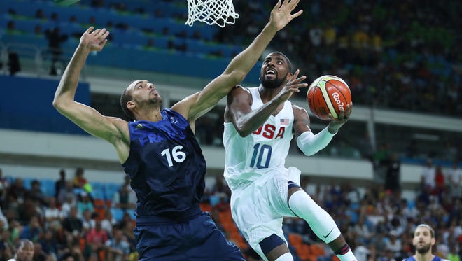 United States guard Kyrie Irving (10) prepares to shoot the ball as France center Rudy Gobert (16) defends during the men's preliminary round in the Rio 2016 Summer Olympic Games at Carioca Arena 1.