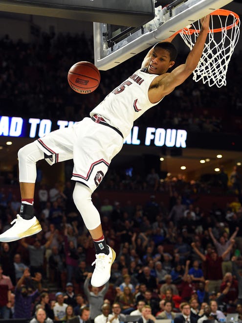 South Carolina's PJ Dozier dunks against Marquette during the first round of the NCAA tournament at Bon Secours Wellness Arena in Greenville, S.C.
