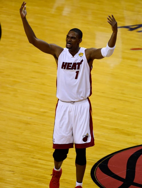 Jun 10, 2014; Miami, FL, USA; Miami Heat center Chris Bosh (1) reacts after shooting a three-pointer against the San Antonio Spurs during the second half of game three of the 2014 NBA Finals
