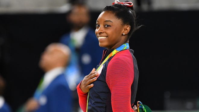 Simone Biles of the United States celebrates winning the gold medal during the women's vault finals in the Rio 2016 Summer Olympic Games at Rio Olympic Arena.