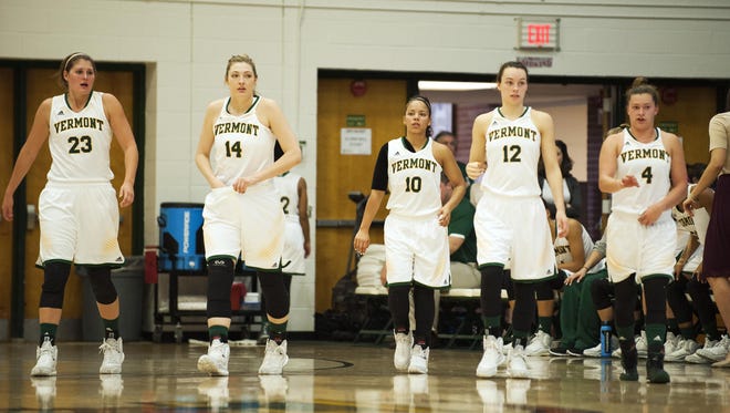 UVM players return to the court following a timeout.