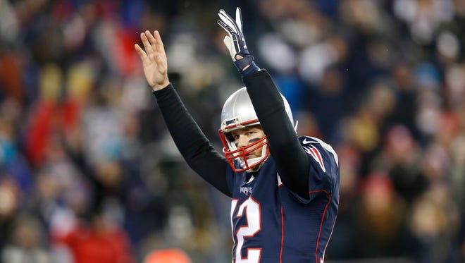 New England Patriots quarterback Tom Brady (12) celebrates a touchdown against the Houston Texans during the fourth quarter in the AFC Divisional playoff game at Gillette Stadium.