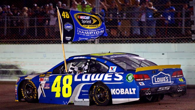 Chase finale: Jimmie Johnson hoists a championship flag in celebration after winning the season points title.