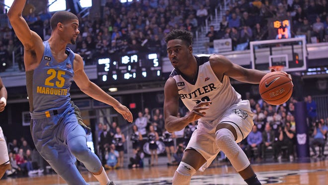 Butler Bulldogs forward Kelan Martin dribbles the ball as Marquette Golden Eagles guard Haanif Cheatham defends in the first half at Hinkle Fieldhouse.