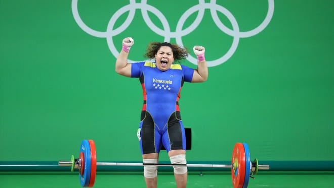 Naryury Alexandra Perez Reveron of Venezuela celebrates her lift during the women's +75kg in the Rio 2016 Summer Olympic Games at Riocentro - Pavilion 2.