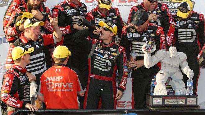 Jeff Gordon drinks champagne in victory lane after winning the AAA 400 at Dover International Speedway On Sept. 28, 2014.