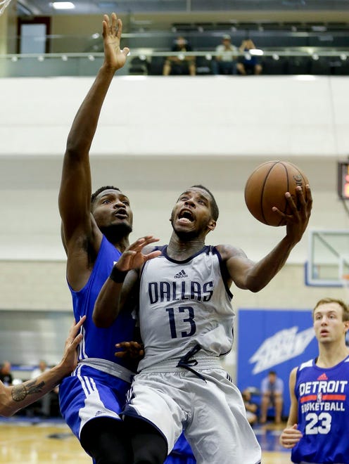 Dallas Mavericks' Dwight Buycks (13) makes a shot after getting by Detroit Pistons' Landry Nnoko during the second half of an NBA Summer League game in Orlando.