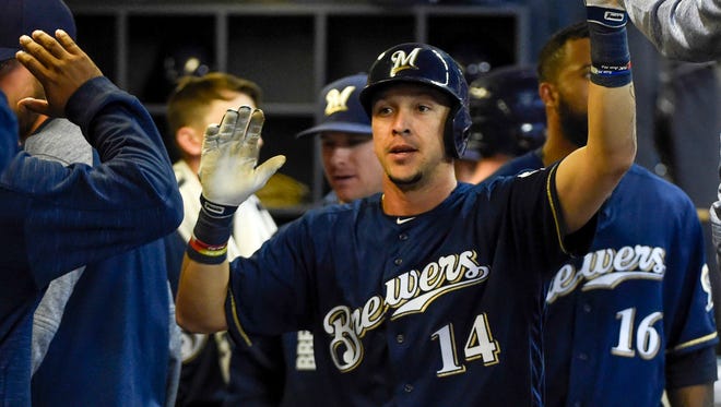 Brewers shortstop Hernan Perez is greeted in the dugout after his home run.