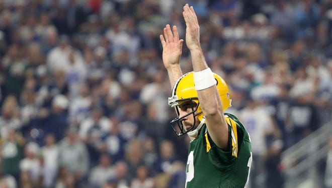 Green Bay Packers quarterback Aaron Rodgers (12) reacts after a touchdown during the second quarter against the Dallas Cowboys in the NFC Divisional playoff game at AT&T Stadium.