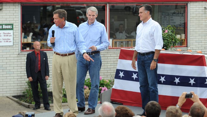 Mitt Romney joins Kasich and Ohio Republican Sen. Rob Portman on stage on Aug. 14, 2012, at a campaign rally in front of Tom's Ice Cream Bowl in Zanesville, Ohio.