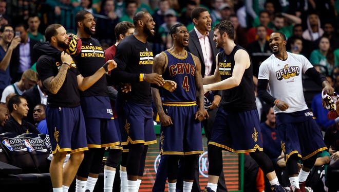 Cleveland Cavaliers forward LeBron James (23), guard Iman Shumpert (4), and teammates celebrate a score during the fourth quarter of game five of the Eastern conference finals of the NBA Playoffs against the Boston Celtics.