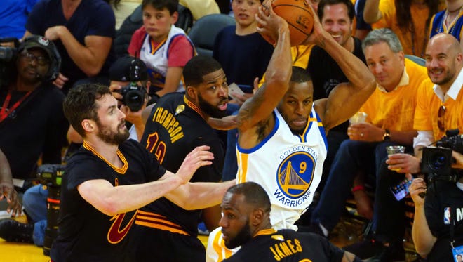 Golden State Warriors forward Andre Iguodala (9) handles the ball against Cleveland Cavaliers forward LeBron James (23) during the third quarter in game five of the 2017 NBA Finals at Oracle Arena.