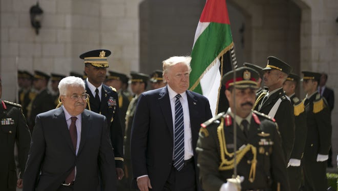 President Trump and Palestinian President Mahmoud Abbas review an honor guard in the West Bank city of Bethlehem Tuesday.