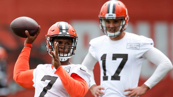 The Cleveland Browns' DeShone Kizer (7) throws while Brock Osweiler (17) looks on during the team's organized team activity in Berea, Ohio.