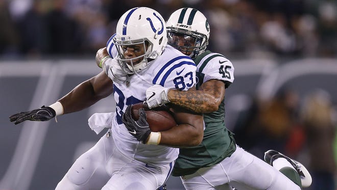 New York Jets strong safety Rontez Miles (45) tries to bring down Indianapolis Colts tight end Dwayne Allen (83) as Allen carries for a first down during the second half at MetLife Stadium in East Rutherford, N.J., on Monday, Dec. 5, 2016.