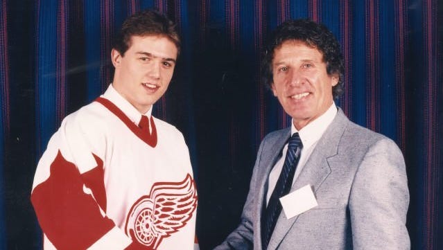 A young Steve Yzerman and Red Wings owner Mike Ilitch shake hands in a 1983 photo from Yzerman's rookie year with the Wings.