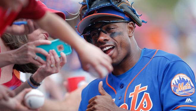 Mets' Curtis Granderson poses for photos and signs autographs for fans before a spring training baseball game against the St. Louis Cardinals on Tuesday, March 28, 2017, in Port St. Lucie, Fla.
