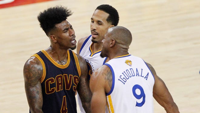 Cleveland Cavaliers guard Iman Shumpert (4) confronts Golden State Warriors forward Andre Iguodala (9) during the second half in game one of the NBA Finals at Oracle Arena.