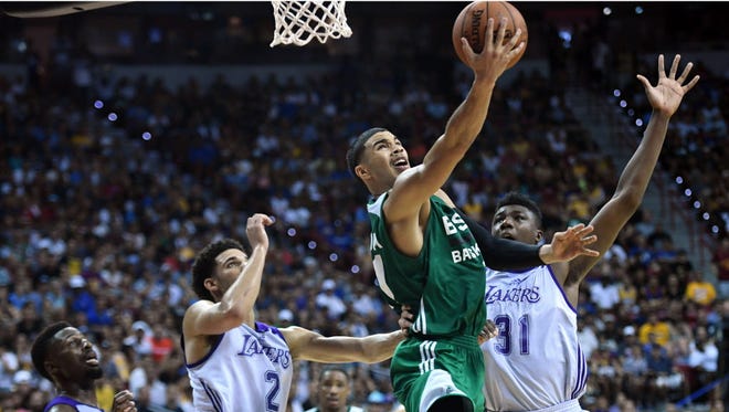 Boston Celtics forward Jayson Tatum (11) goes up for a layup against the Los Angeles Lakers during the second half at Thomas & Mack Center.