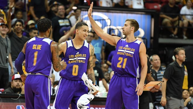 Los Angeles Lakers guard Vander Blue (1) and forwards Kyle Kuzma (0) and Travis Wear (21) celebrate on the sideline during an NBA Summer League playoff game against the Dallas Mavericks.