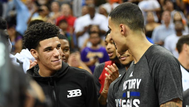 Los Angeles Lakers guard Lonzo Ball (2) talks with forward Kyle Kuzma (0) as they celebrate after defeating the Portland Trail Blazers in the NBA Summer League final.