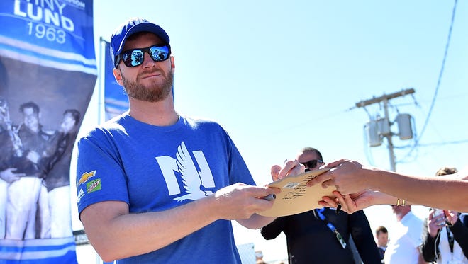 Dale Earnhardt Jr. signs autographs before the start of the 2017 Daytona 500.