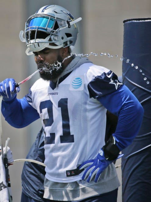 Dallas Cowboys running back Ezekiel Elliott takes a break to drink water during practice in Frisco, Texas.