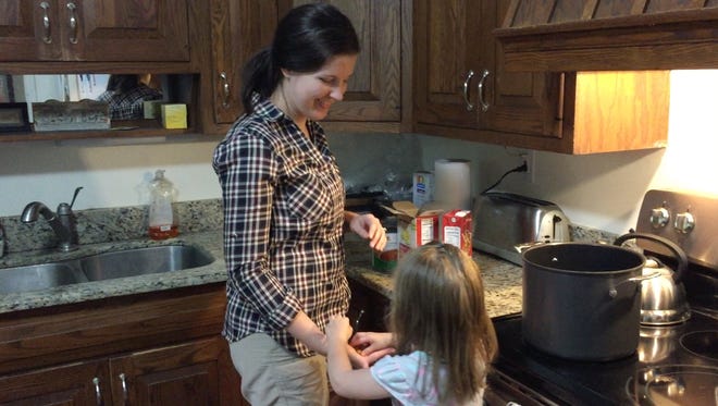 Cara Richardson and her daughter Annica, 3, often make trips to their deep freezer for dinner. Planning and preparing meals ahead is one way Richardson stays sane and healthy.