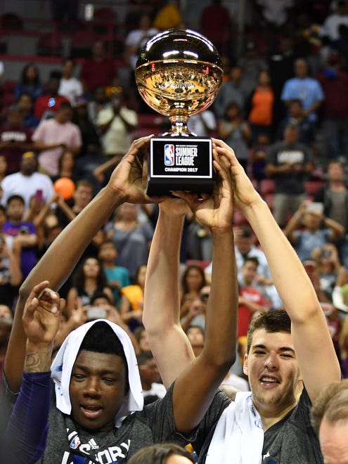 Los Angeles Lakers centers Thomas Bryant (31) and Ivica Zubac (40) celebrate with the NBA Summer League championship trophy.