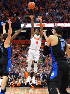 Syracuse Orange guard John Gillon (4) takes the game winning shot in the final moments of the game against the Duke Blue Devils at the Carrier Dome. The Orange won 78-75.