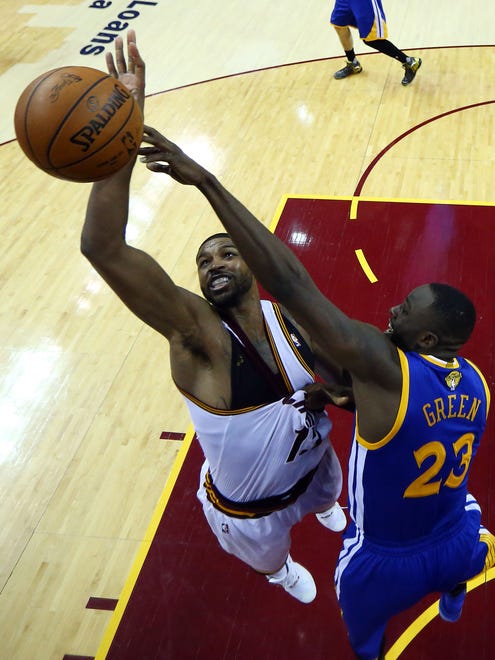Cleveland Cavaliers center Tristan Thompson (13) and Golden State Warriors forward Draymond Green (23) go after a loose ball in Game 6 of the NBA Finals at Quicken Loans Arena.