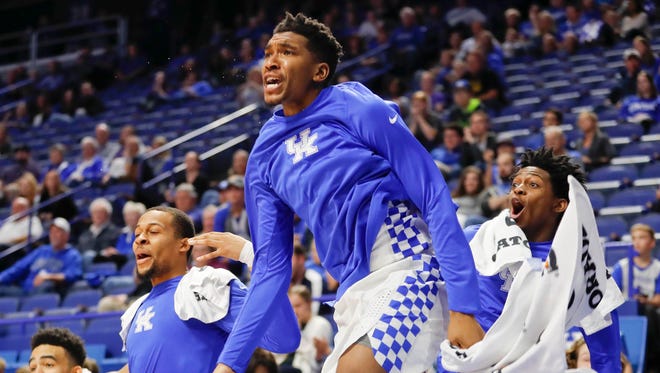 Kentucky Wildcats guard Malik Monk (5) guard De'Aaron Fox (0) and guard Isaiah Briscoe (13) celebrate on the sideline during the game against the Asbury Eagles in the second half at Rupp Arena. Kentucky defeated Asbury 156-63.