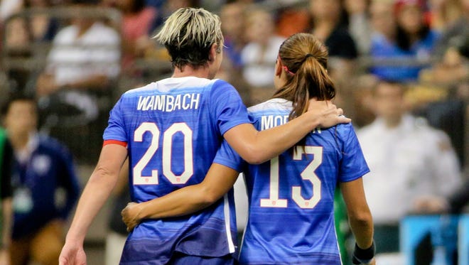 Abby Wambach (20) leaves the field with Alex Morgan (13) after her final career game with the U.S. women's national team.
