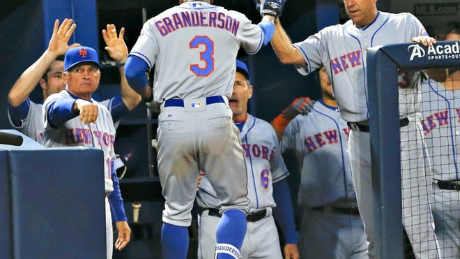 Mets' Curtis Granderson is greeted by teammates after hitting a grand slam in the second inning against the Atlanta Braves on Friday in Atlanta.