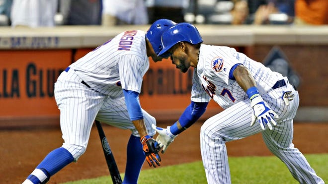 Mets Curtis Granderson, left, greets Jose Reyes after Reyes hit a fourth-inning, solo home run against the Washington Nationals, Thursday, July 7, 2016, in New York.