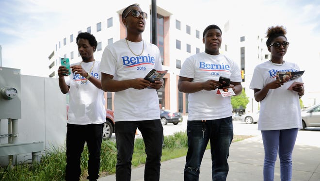 Gashi Thompson, left, Terell Tinsley, Jamal Tisdale and Jasmine Thomas canvass for Democratic presidential candidate Bernie Sanders during an April 25, 2016, rally to mark the anniversary of the death of Baltimore city resident Freddie Gray.