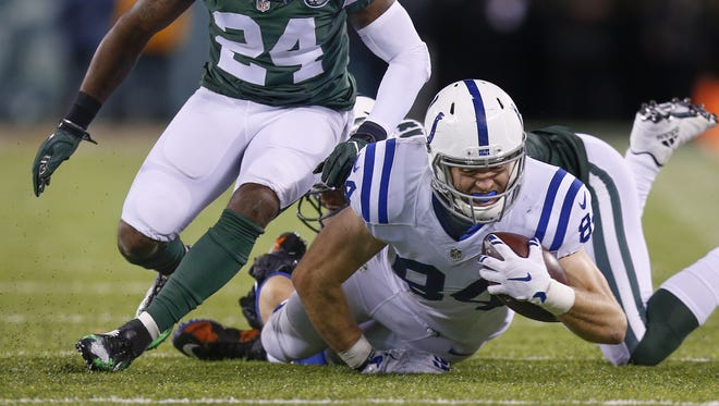 Indianapolis Colts tight end Jack Doyle (84) fights for a 2 yard gain after a pass from Indianapolis Colts quarterback Andrew Luck (12) during the 1st half against the New York Jets at MetLife Stadium in East Rutherford, N.J., on Monday, Dec. 5, 2016.