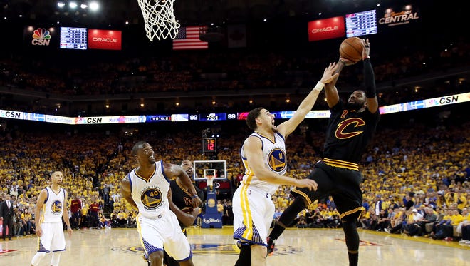 Cleveland Cavaliers guard Kyrie Irving (2) shoots the ball against Golden State Warriors guard Klay Thompson (11) during the fourth quarter in Game 5 of the NBA Finals at Oracle Arena.