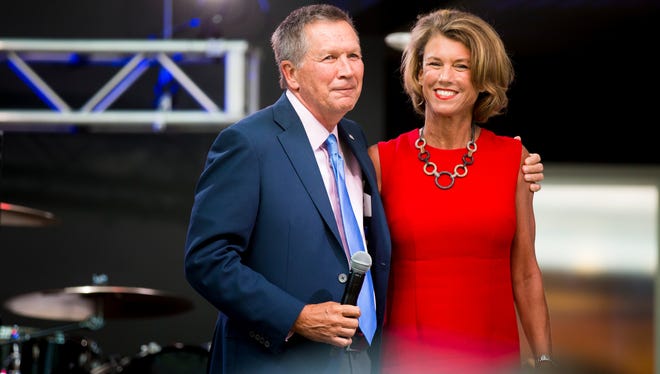 Kasich embraces his wife, Karen, in front of a large crowd at an event he hosted at the Rock and Roll Hall of Fame in Cleveland on July 19, 2016.