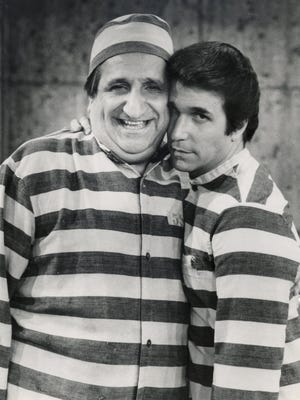 In this photo provided by ABC in 1981, Al Molinaro, left, and Henry Winkler pose in character in an episode from "Happy Days."