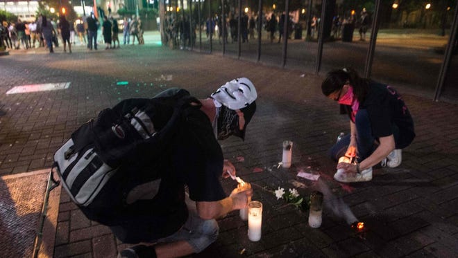 Protesters light candles on September 22, 2016 at the site where Justin Carr was shot on September 21 during a demonstration against police brutality in Charlotte, North Carolina, following the shooting of Keith Lamont Scott by police two days earlier and two nights of riots. Carr died of his injuries on September 22.