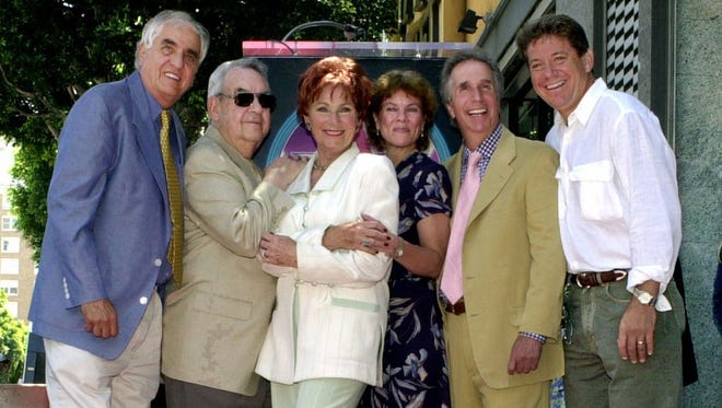 FILE - In this July 12, 2001 file photo, Garry Marshall, from left, Tom Bosley, Marion Ross, Erin Moran, Henry Winkler, and Anson Williams of the television show "Happy Days," pose after Ross received a star on the Hollywood Walk of Fame in the Hollywood section of Los Angeles. Moran, the former child star who played Joanie Cunningham in the sitcoms "Happy Days" and "Joanie Loves Chachi," has died at age 56. Police in Harrison County, Indiana said that she had been found unresponsive Saturday, April 22, 2017, after authorities received a 911 call. (AP Photo/E.J. Flynn, File) ORG XMIT: CAET961