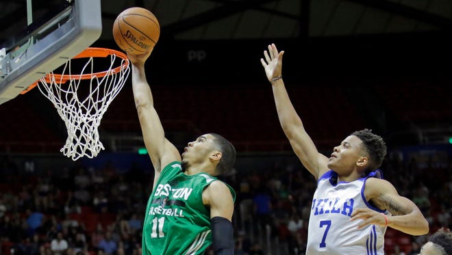 Boston Celtics forward Jayson Tatum (11) lays the ball in as Philadelphia 76ers guard Markelle Fultz (7) defends during the second half of an NBA Summer League game in Salt Lake City.